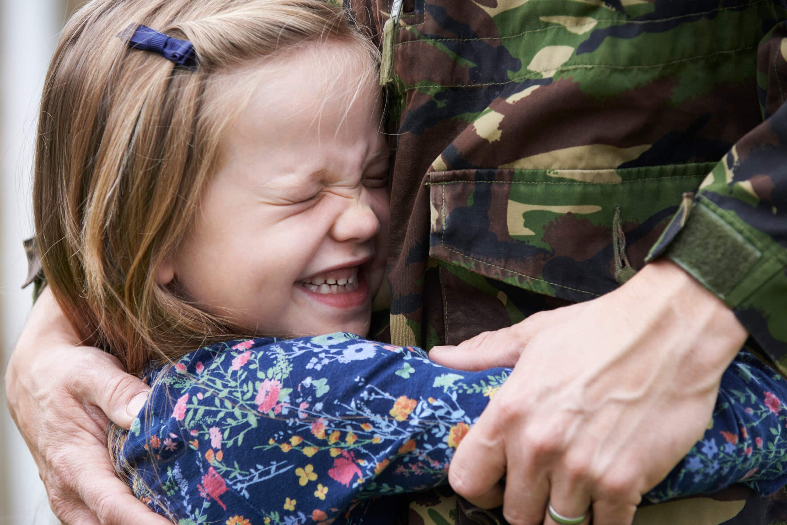 Soldier being hugged by daughter